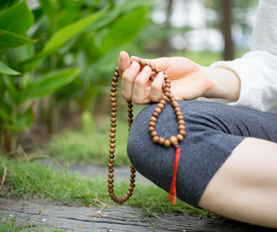 Japa Mala beads, one person holding one end and another person